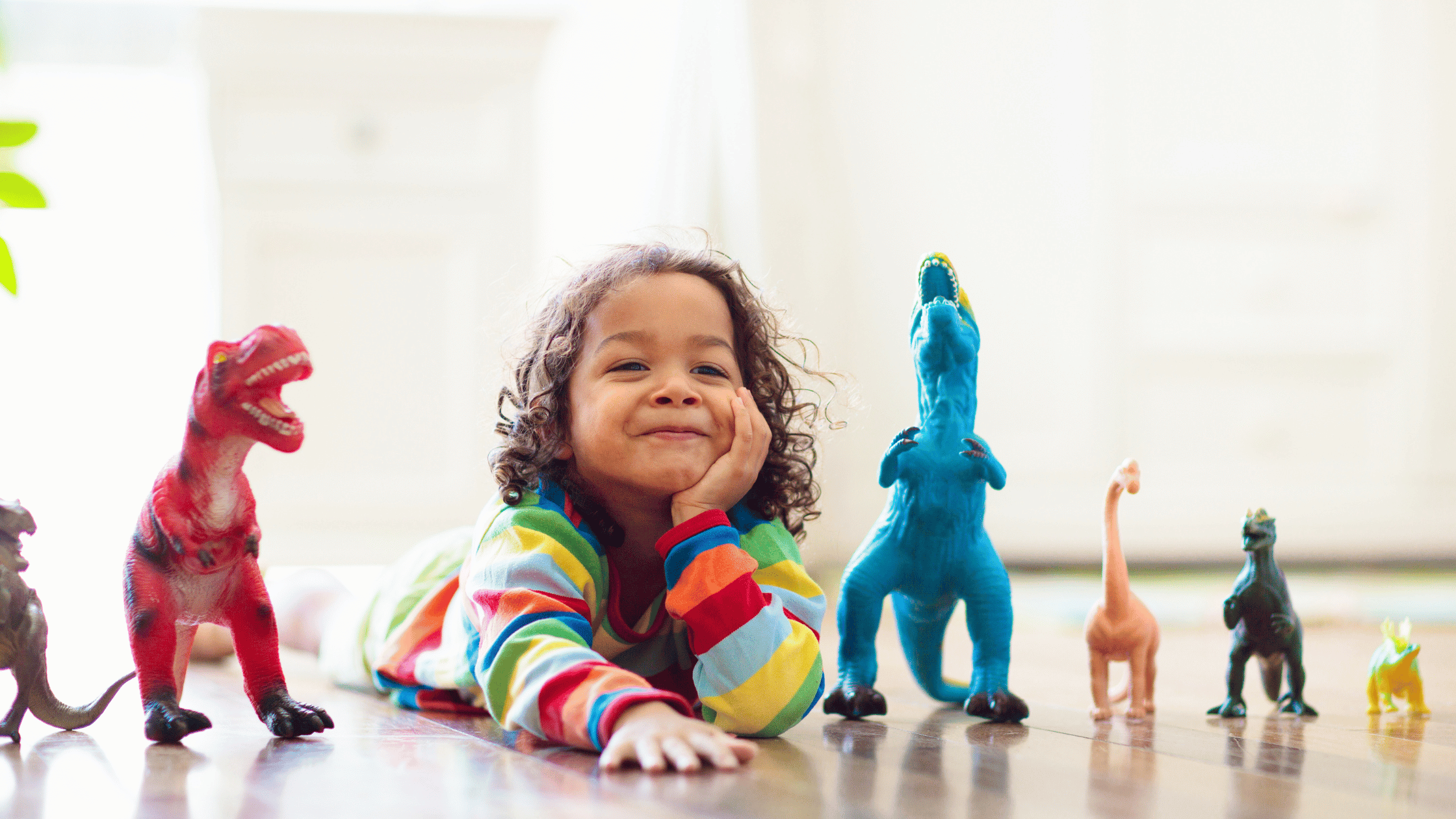 hidden animals - a game you can play in french - child with dinosaurs around him